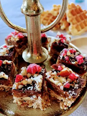 a plate of brownies with a pepper shaker on top at B&B 't klein GELUK in Ham
