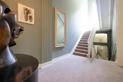 a hallway with a staircase and a stair case at La Calamande En Ville in Brussels