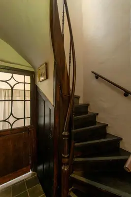 a spiral staircase in a house with a window at Coeur Saint-Jacques in Brussels