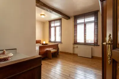 a living room with wooden floors and windows at Coeur Saint-Jacques in Brussels