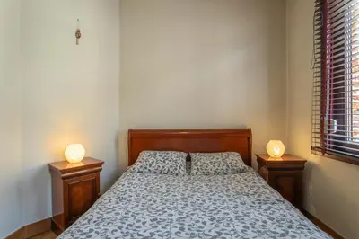 a bedroom with a bed with two lamps on tables at Coeur Saint-Jacques in Brussels