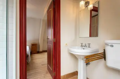 a bathroom with a sink and a mirror at Coeur Saint-Jacques in Brussels