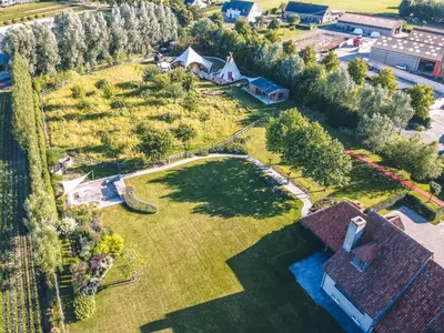 an aerial view of a large yard with a house at Comfort Tipi Marie, Tipi Bo Deluxe & tent Nicolaï - 'Glamping in stijl' in Lembeke