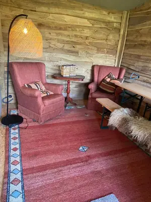 a living room with two chairs and a table at Comfort Tipi Marie, Tipi Bo Deluxe & tent Nicolaï - 'Glamping in stijl' in Lembeke