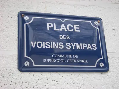 a sign on a wall that reads place des vossensyssyssyss at Au Bout du Jardin in Waterloo