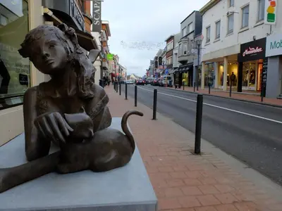 a statue of a woman sitting on a street at Au Bout du Jardin in Waterloo