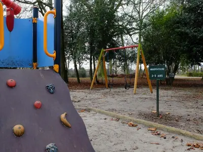 a playground with a slide in a park at Au Bout du Jardin in Waterloo