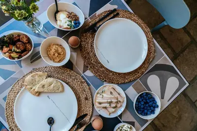 a table with plates of food on top of it at Villa Parkbos in De Pinte
