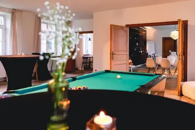 a living room with a pool table and a candle at Villa Parkbos in De Pinte