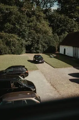 two cars parked in the driveway of a house at Villa Parkbos in De Pinte