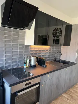 a kitchen with a sink and a counter top at Cosy appartement with canal view in Brussels
