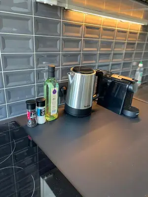 a counter top with a coffee maker and a pot on it at Cosy appartement with canal view in Brussels