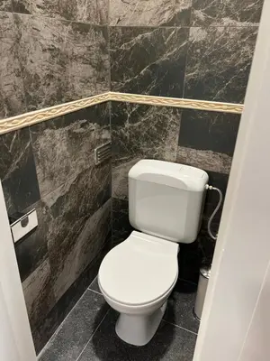 a bathroom with a white toilet in a room at Cosy appartement with canal view in Brussels
