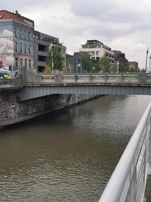 a bridge over a river with buildings at Cosy appartement with canal view in Brussels