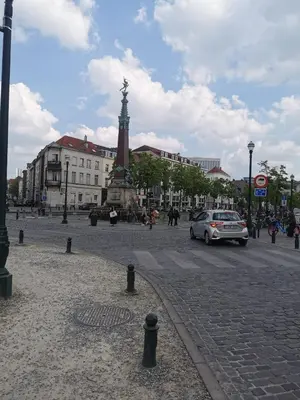 a city street with a car driving down a street at Cosy appartement with canal view in Brussels