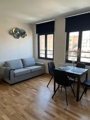 a living room with a couch and a table at Cosy appartement with canal view in Brussels