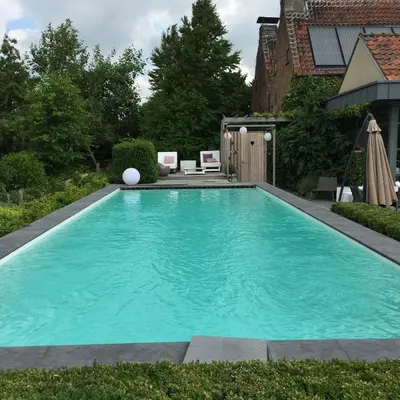 a swimming pool in the backyard of a house at B&B Vennehoeve in Vremde