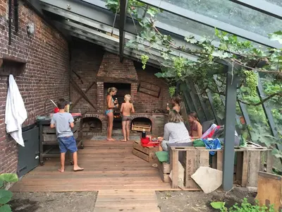 a group of people standing around in a patio at B&B Vennehoeve in Vremde