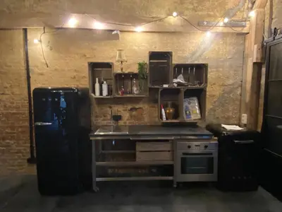 a kitchen with a refrigerator and a stove at B&B Vennehoeve in Vremde