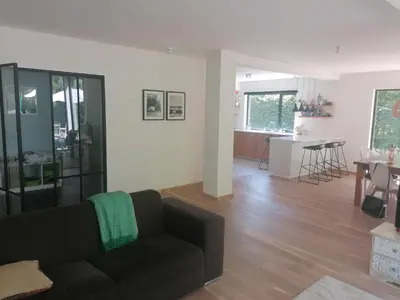 a living room with a couch and a dining room at villa in Kontich