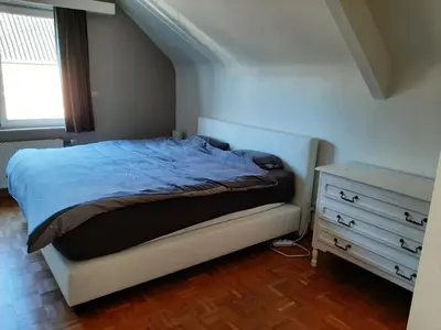 a bedroom with a bed and a dresser at villa in Kontich
