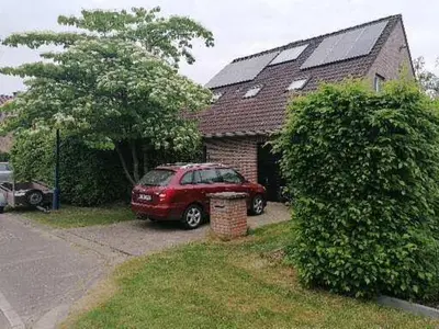a red car parked in front of a house at villa in Kontich