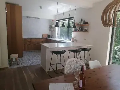 a kitchen with a table and chairs and a counter at villa in Kontich