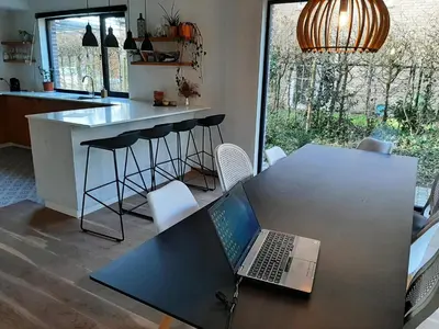 a laptop computer sitting on a table in a kitchen at villa in Kontich