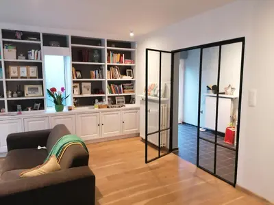 a living room with a couch and a mirror at villa in Kontich
