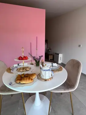 a white table with bread and pastries on it at Whaaw Herentals in Herentals