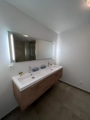 a bathroom with a sink and a large mirror at Whaaw Herentals in Herentals