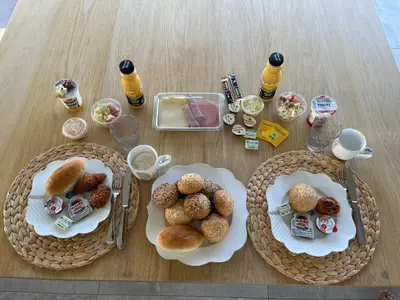 a table with two plates of pastries and drinks at Whaaw Herentals in Herentals