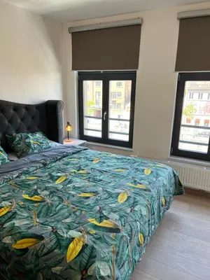 a bedroom with a bed with a colorful bedspread at Charming duplex on the canal Brussels in Brussels