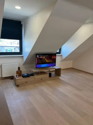 a living room with a flat screen tv on a table at Charming duplex on the canal Brussels in Brussels