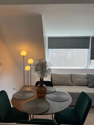 a living room with two tables and a couch at Charming duplex on the canal Brussels in Brussels
