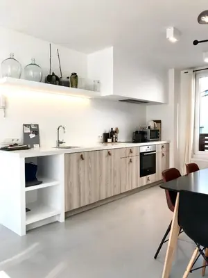 a kitchen with white cabinets and a table at Bright City Design House! in Antwerp