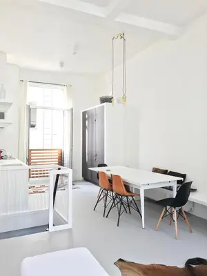 a white dining room with a white table and chairs at Bright City Design House! in Antwerp