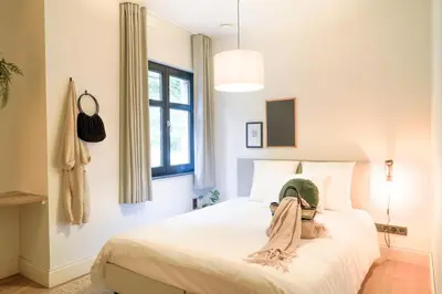 a bedroom with a bed with a hat on it at Weynhoven in Brecht