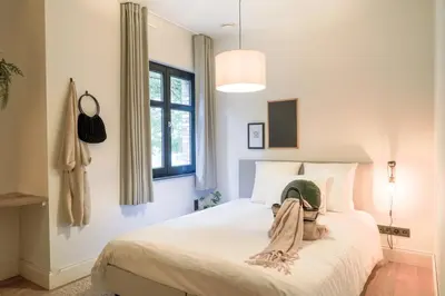 a bedroom with a bed with a hat on it at Weynhoven in Brecht
