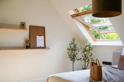 a bedroom with a bed with a window and a table at Weynhoven in Brecht