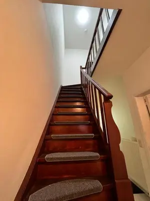 a stairway with wooden stairs in a house at Ganha holiday house in Antwerp