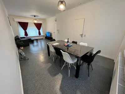 a dining room with a table and chairs at Ganha holiday house in Antwerp