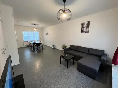a living room with a couch and a table at Ganha holiday house in Antwerp