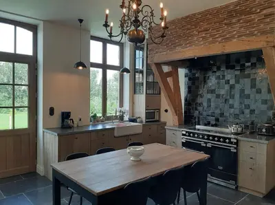 a kitchen with a wooden table and a stove at Huis Potaerde, vakantiewoning op boerderij - luxe landhuis nabij Brussel in Merchtem
