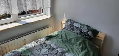 a bedroom with a bed and a window at SUPERB APPARTEMENT WITH 3 BED ROOMS IN ANTWERPEN in Antwerp