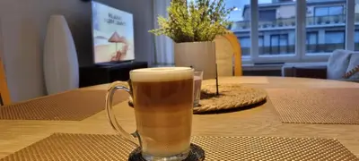 a glass of beer sitting on a table at SUPERB APPARTEMENT WITH 3 BED ROOMS IN ANTWERPEN in Antwerp