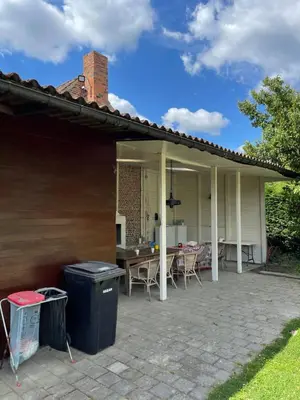 a house with a patio with a table and chairs at Tents @ Tomorrowland in Rumst