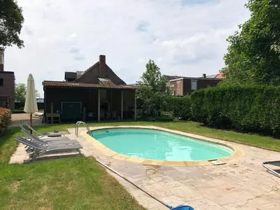 a swimming pool in the yard of a house at Tents @ Tomorrowland in Rumst