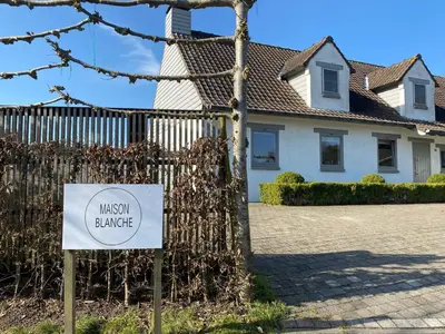 a sign in front of a house with a museum garage at B&B Maison Blanche in Ghent