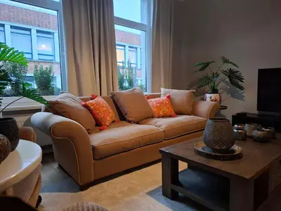 a living room with a couch and a table at Sint Andries Duplex in Antwerp